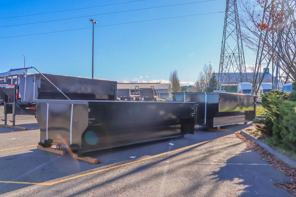 Roll-off dumpster ready for waste disposal at job site for Demolition Dumpster Rental in Oak Island